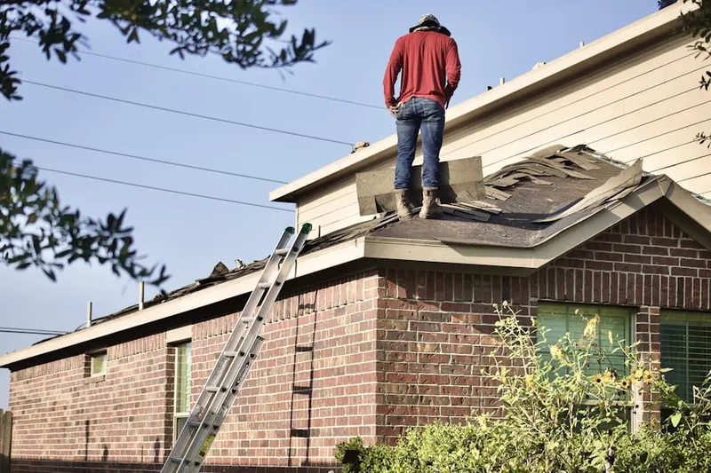Professional roofer working on a residential roof in Pampa